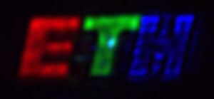 The coloured logo was created using the new ETH researchers‘ Fourier pixels. The letter “E” is roughly 1 millimetre tall on the camera. (Image: Glauser YM, Vonk SJW, et al., Nature 2026)