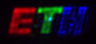 The coloured logo was created using the new ETH researchers‘ Fourier pixels. The letter “E” is roughly 1 millimetre tall on the camera. (Image: Glauser YM, Vonk SJW, et al., Nature 2026)